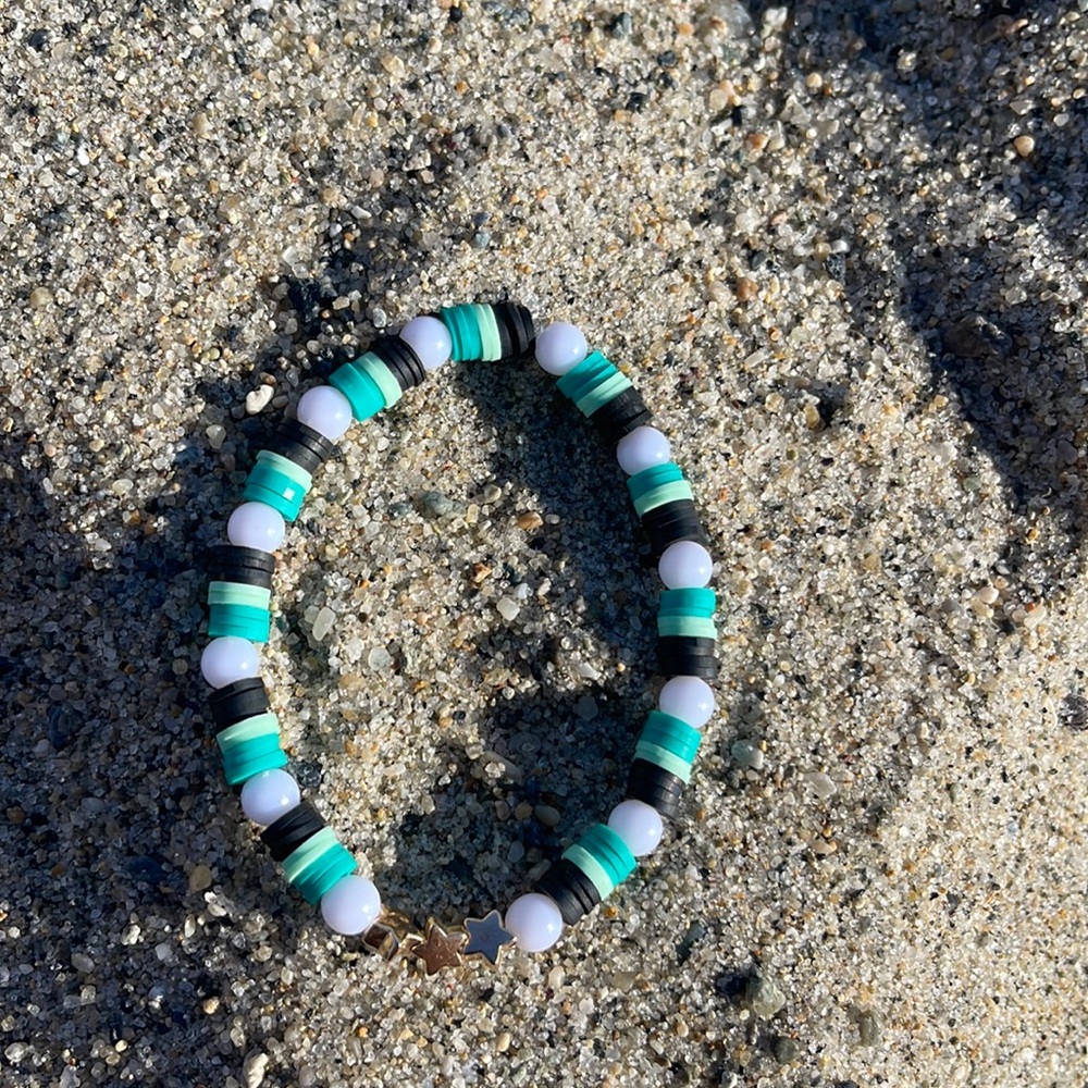 Bracelet “stars” black, green and white. 3 gold  colored stars.